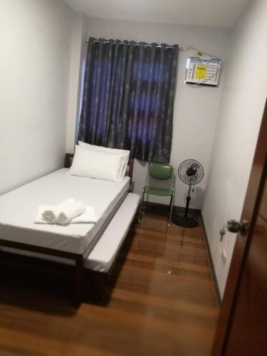 a small room with a bed and a window at Overnight Villa Transient House in Sorsogon