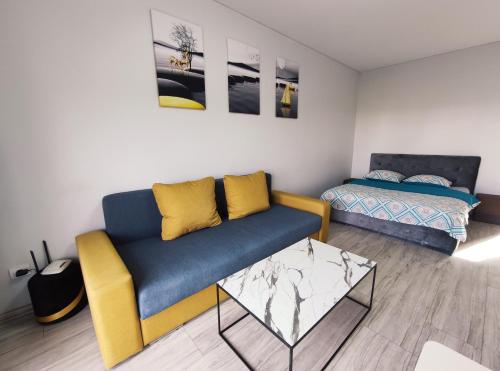 a living room with a couch and a bed at K-Town - Apartments ViaBaltic Kaunas in Kaunas