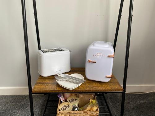a shelf with a toaster and other appliances on it at Innisfree Guest House in Fort William