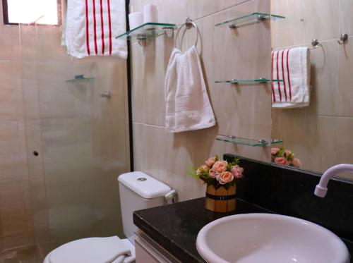 a bathroom with a sink and a toilet and a shower at Casa Lua Nova na Praia de Peroba, Maragogi in Maragogi