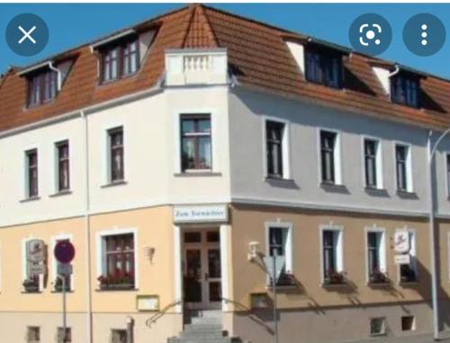 a screenshot of a building with a screenshot of a phone at Hotel zum Torwächter in Pritzwalk