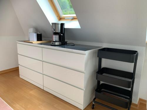 a white dresser with a coffee maker on top of it at Ferienwohnung Moseltraum in Cochem