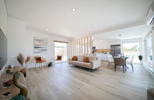 a living room with a couch and a table and chairs at Monte Calmaria by Estilo Lusitano, with private pool and Jacuzzi in Grândola