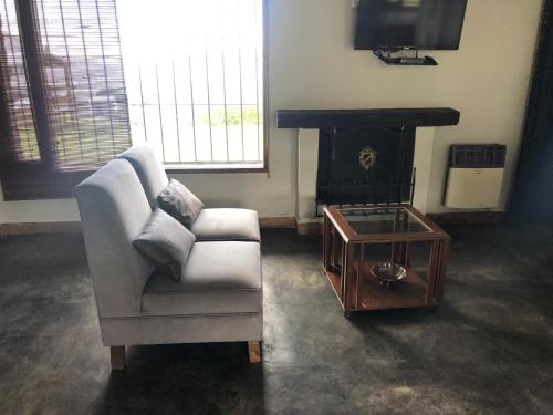 a living room with a chair and a coffee table at Puro Campo in Tafí del Valle