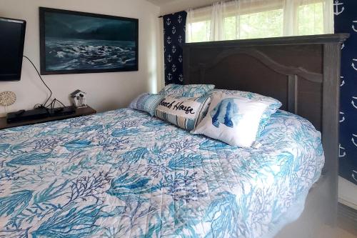 1 dormitorio con 1 cama con edredón azul y blanco en Nautical Daze, en Oak Bluffs