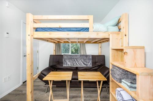 a room with a bunk bed and a table at AlohAlaska Studio in Girdwood