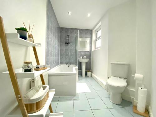 a white bathroom with a toilet and a sink at LOVELY STYLISH APARTMENT NEAR PENNY LANE! FREE PARKING in Liverpool