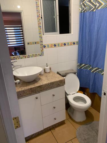 a bathroom with a toilet and a sink at Departamento para 4 personas Constitución in Constitución