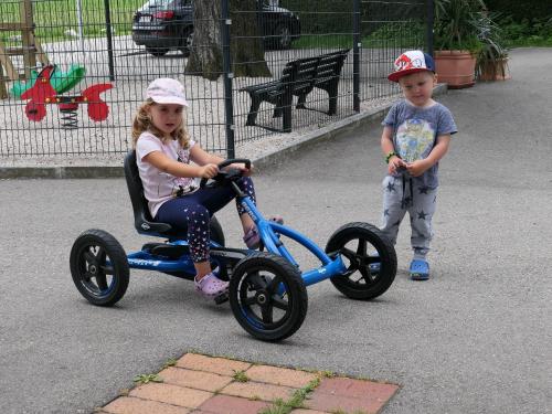 a little girl riding a tricycle with a little boy at Landgasthof Spitzerwirt in Sankt Georgen im Attergau