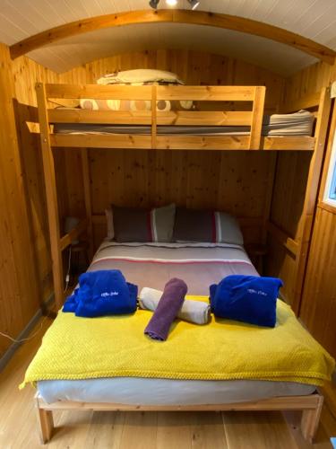 a bedroom with a bunk bed with two towels on it at Luxury Railway carriage with own private hot tub in Clodock