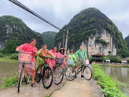 un grupo de personas montando bicicletas en un puente en Tam Coc Horizon Bungalow, en Ninh Binh