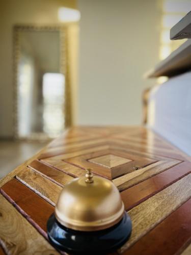 a brass bell sitting on top of a wooden table at Lejos Eco Retreat in Vieques