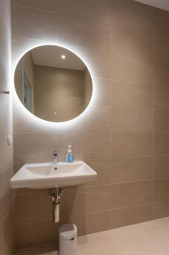 a bathroom with a sink and a mirror at Vallikraavi Studio Apartment in Tartu