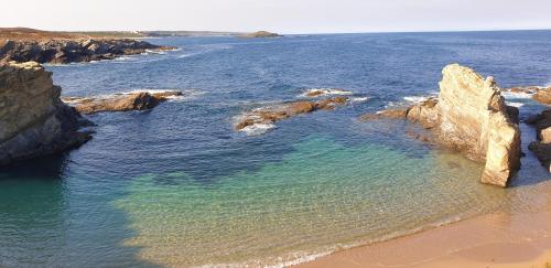 an aerial view of a beach with rocks and water at Monte Calmaria by Estilo Lusitano, with private pool and Jacuzzi in Grândola