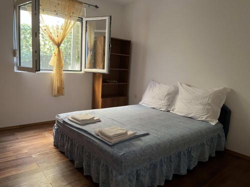a bedroom with a bed with two towels on it at Apartman Any Bar in Bar