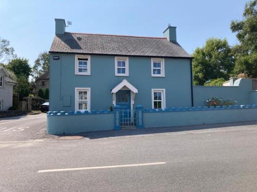 a blue house on the side of a street at Mounvaud Lodge in Stradbally