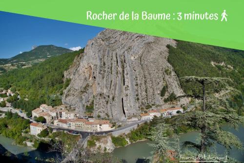 a picture of a mountain with a town and a river at Le Saunerie - Sleep in Sisteron in Sisteron