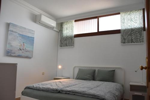 a bedroom with a bed and a window at ELSA TAURO TOPAZ in Mogán