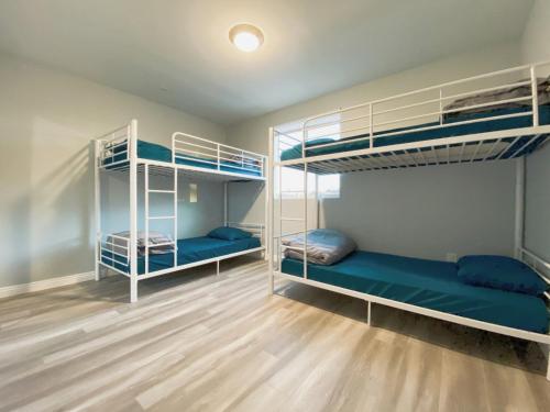 two bunk beds in a room with wooden floors at Modern Hostel in Los Angeles