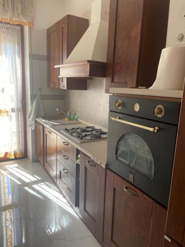 a kitchen with a black stove top oven in it at Appartamento Mire&Geo in Voghera