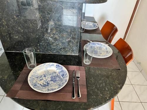 a black table with plates and silverware on it at Puerto de Villas in Recife