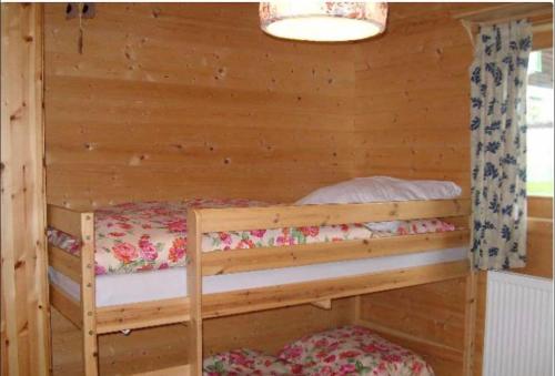 a bedroom with two bunk beds in a cabin at Ferienhaus Schlagintweit in Drachselsried