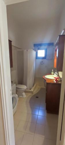 a bathroom with a toilet and a sink at George in Myrties