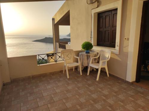 a table and chairs with a view of the ocean at George in Myrties