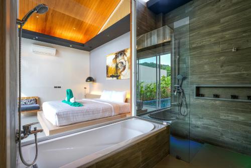 a bathroom with a tub and a bed and a shower at Sunpao Pool Villa by HCR in Layan Beach