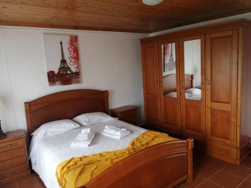 a bedroom with a bed with two towels on it at Casa do Lajedo in Porto Martins