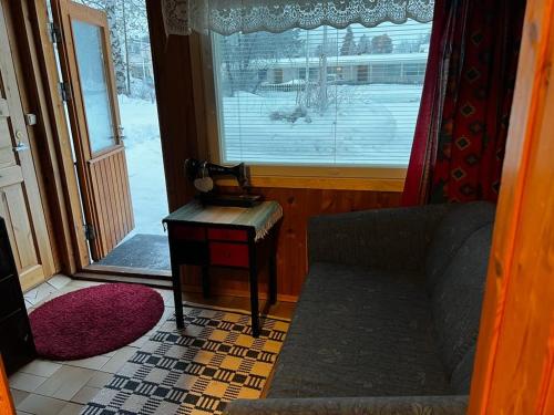a living room with a couch and a window at Adorable 1-bedroom cottage/guesthouse in Kittilä in Kittilä