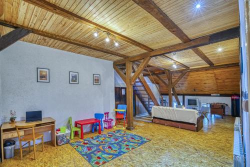 a living room with a bed and a table and chairs at Grabnicka Arkadia in Stare Juchy