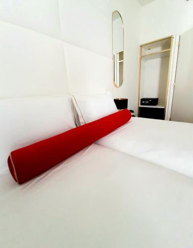 a red pillow on a white bed in a room at Lisbon City Hollywood Hotel by City Hotels in Lisbon