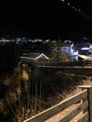 a night view of a city with a fence at Haus Sonja in Finkenberg