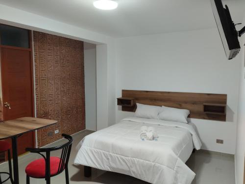 a bedroom with a bed with a stuffed animal on it at EGIPTO HOTEL BOUTIQUE in Arequipa