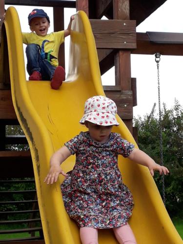 two children playing on a slide at a playground at Landgasthof Spitzerwirt in Sankt Georgen im Attergau