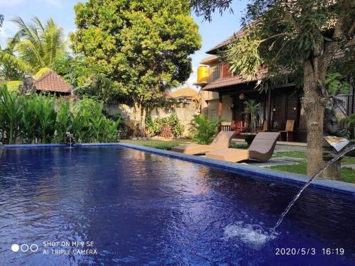 een zwembad voor een huis bij TEGESWOODHOUSE A with WiFi,Ac in Ubud