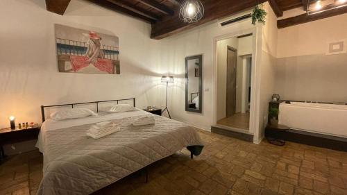 a bedroom with a bed and a bathroom with a tub at Rome SuiteRelax in Rome