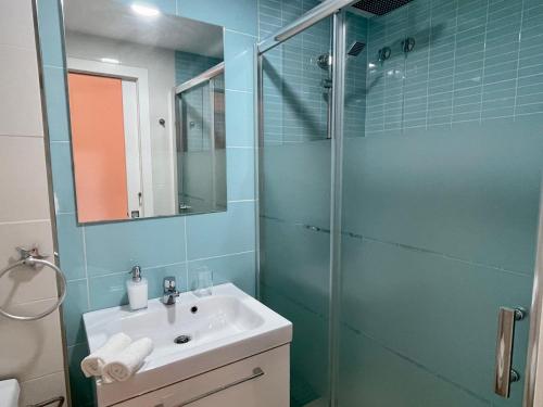 a bathroom with a sink and a glass shower at Royal Pearl Marbella in Marbella
