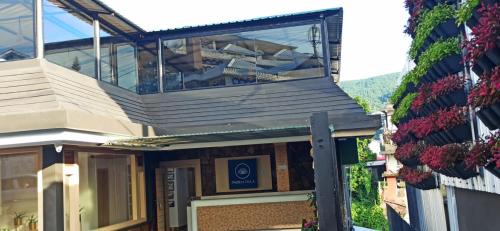 a building with a balcony on top of it at PHIBHA VILLA in Shillong