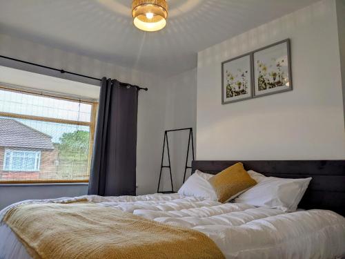 a bedroom with a large bed with a window at CityHost Apartments - Newcastle in Elswick