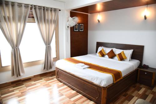 a bedroom with a bed and a window at PHIBHA VILLA in Shillong