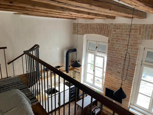 a room with a staircase and a brick wall at Old Port Riverside Apartments in City Center in Belgrade