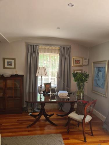 a living room with a table and a chair at The Great Gatsby Houghton in Johannesburg