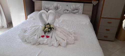 a white bed with two swans on it at La Necussella in Anacapri