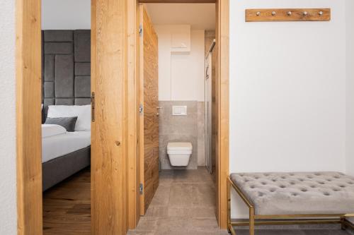 a bathroom with a bed and a toilet in a room at Granit Appartements in Mauterndorf