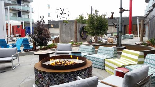 a fire pit on a patio with chairs and tables at Hotel Zephyr San Francisco in San Francisco
