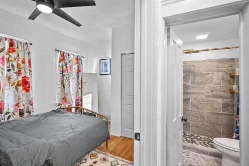 a bedroom with a bed and a bathroom at Center of Little Italy #1 in Cleveland