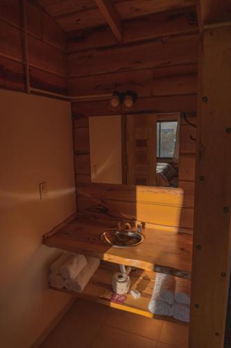 a bathroom with a sink and a mirror at Complejo Anthea in Villa Yacanto