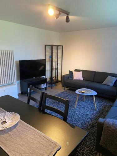 a living room with a couch and a table at The Little Guesthouse Downtown - Keflavik Airport in Keflavík